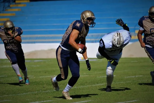 American football player running with ball